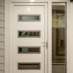 White entrance door with a all glass side lite.