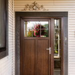 wooden color and look on this entrance doors make it look just stunning which 3/4 of the door are made of that material and 1/4 of glass and it features a glass sidelite a