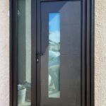 Jet Black custom- tailored entrance door with a glass side panel.