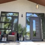 Stunning entrance area inspiration in black/brown, customized door panel with special cutouts and all glass sidelites and transome. Also has a huge window the same size beside made up from four horizontal and one vertical glass sections.