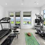 View of a well equipped home Gym. with a outside view though premium quality windows.