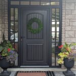 Stunning black entrance door with sidelites and transom.