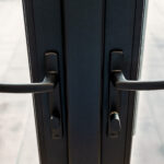 Black, sleek, door handles include key- nobs, all in stylish matt black.