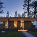Illuminated by the sunset, this modern home featuring floor-to-ceiling ACCESS windows and oversized glass doors.
