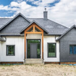 Contemporary home exterior with custom windows, modern entrance door, and timeless architectural details.